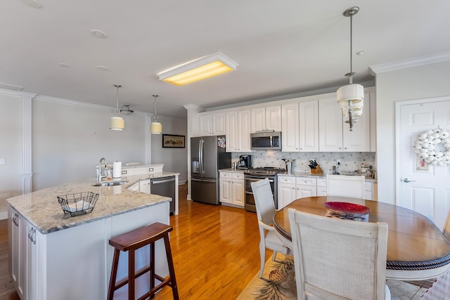 3401 Seaboard Cir Unit 3401, North Wildwood, NJ 08260 - kitchen with appliances with stainless steel finishes, a sink, light wood finished floors, tasteful backsplash, and ornamental molding
