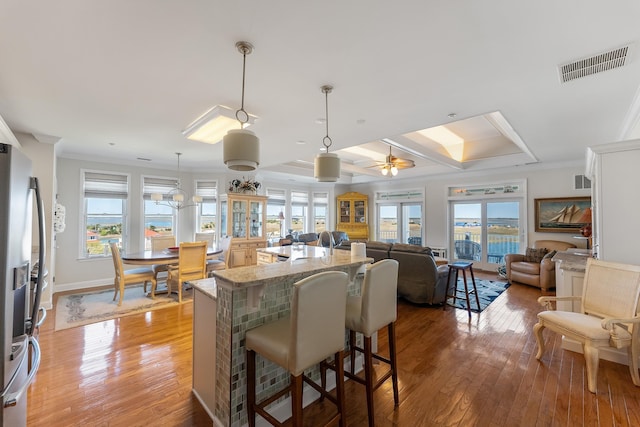 3401 Seaboard Cir Unit 3401, North Wildwood, NJ 08260 - kitchen with visible vents, light stone counters, light wood finished floors, and a kitchen bar