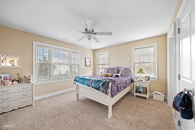 carpeted bedroom featuring ceiling fan and baseboards