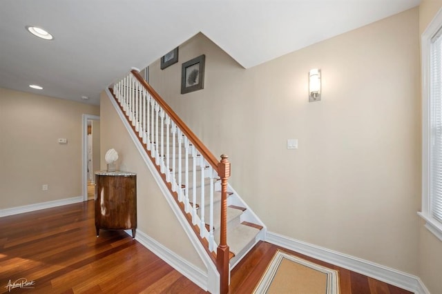 stairway with recessed lighting, wood finished floors, and baseboards