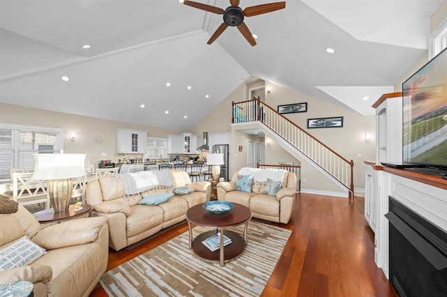 living area featuring ceiling fan, wood finished floors, stairs, high vaulted ceiling, and recessed lighting