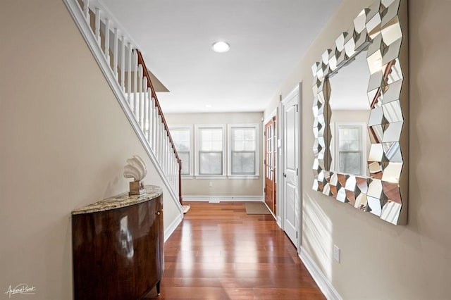 interior space featuring recessed lighting, dark wood finished floors, stairway, and baseboards