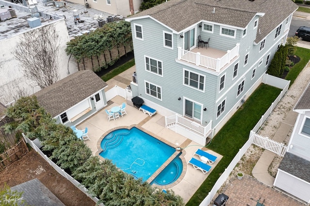 view of swimming pool with outdoor dining space, an outdoor structure, a fenced backyard, and a fenced in pool