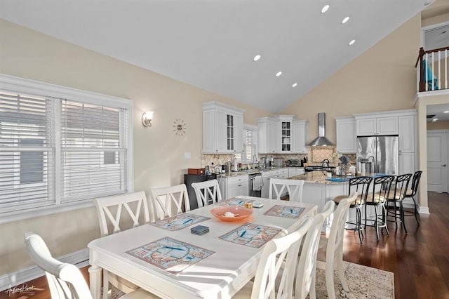 dining space with dark wood-style floors, recessed lighting, high vaulted ceiling, and baseboards