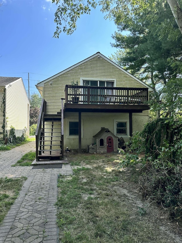 back of house with a wooden deck