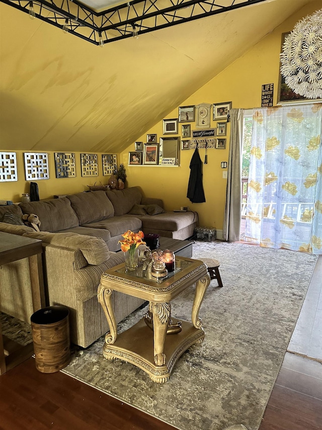 living room featuring lofted ceiling and hardwood / wood-style flooring