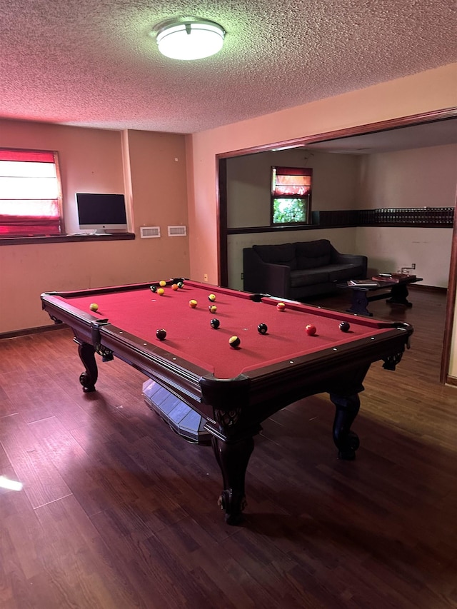 game room featuring hardwood / wood-style flooring, a textured ceiling, and pool table