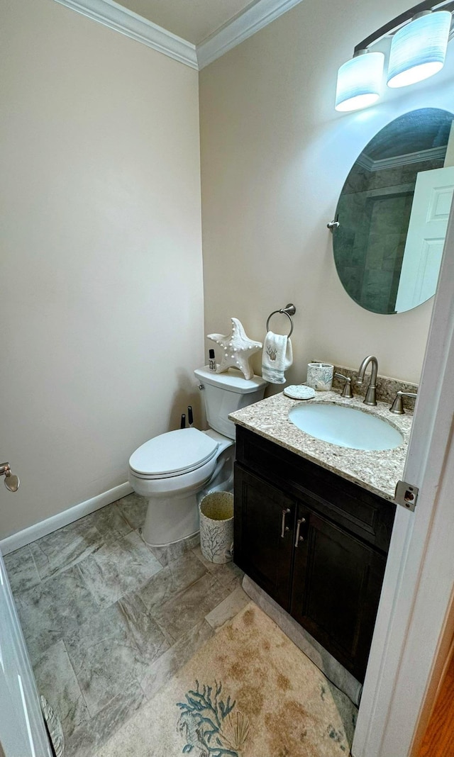 bathroom featuring ornamental molding, vanity, and toilet