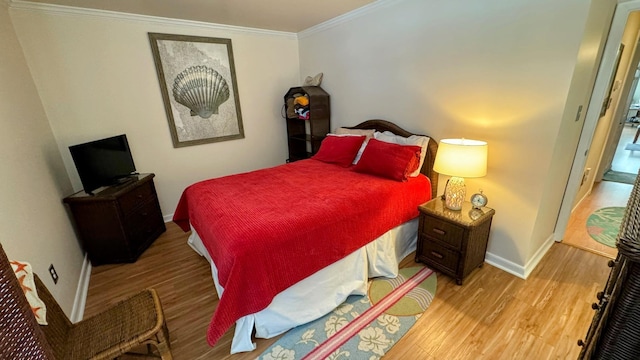 bedroom featuring ornamental molding and light hardwood / wood-style floors