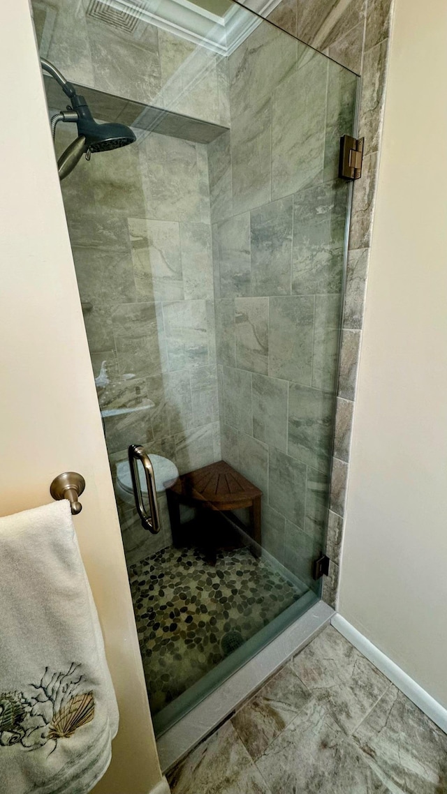 bathroom featuring a shower with shower door