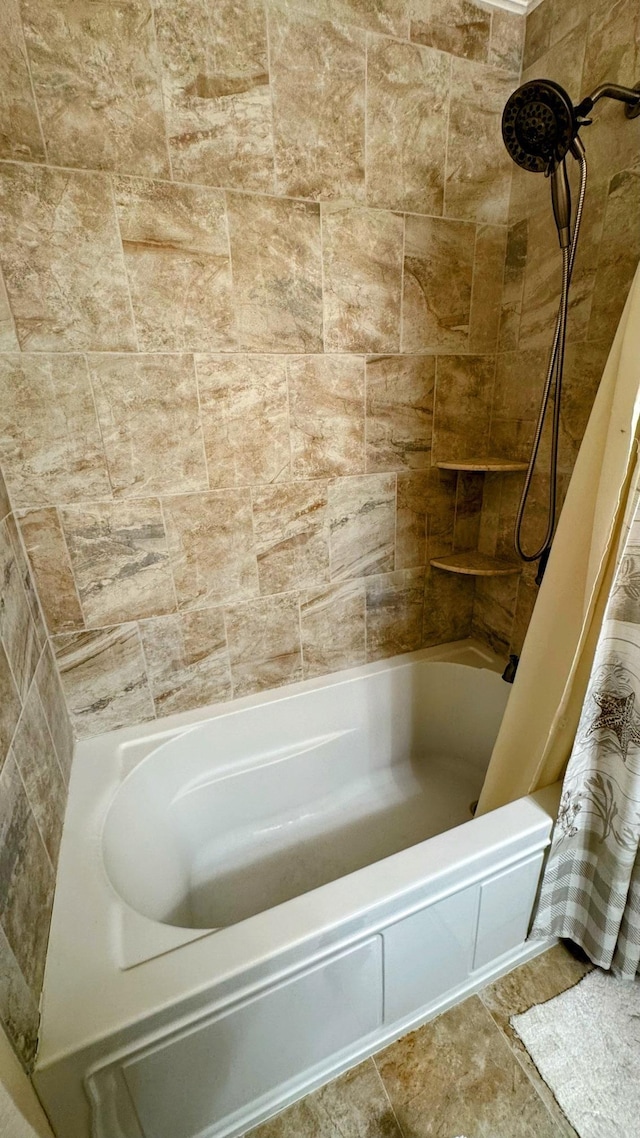 bathroom with shower / bath combination with curtain