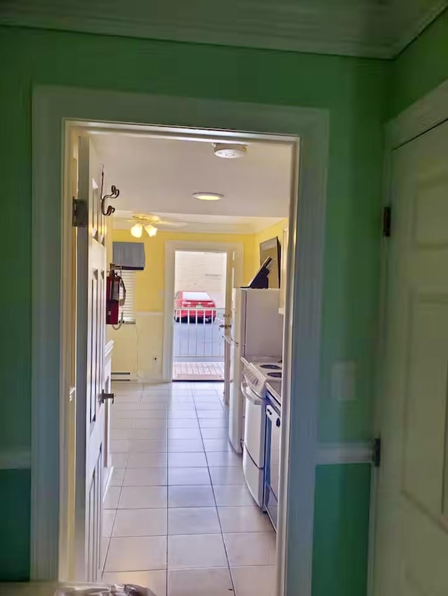 corridor with baseboard heating and light tile patterned flooring