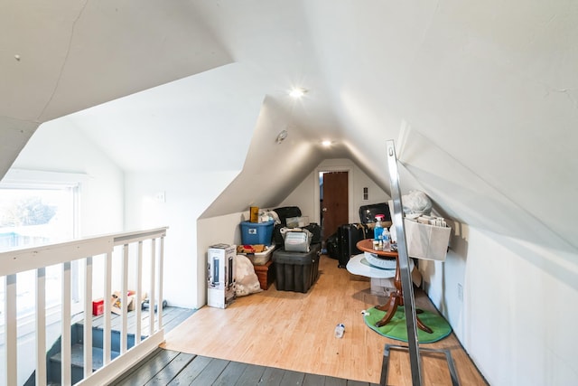 bonus room with lofted ceiling and wood finished floors