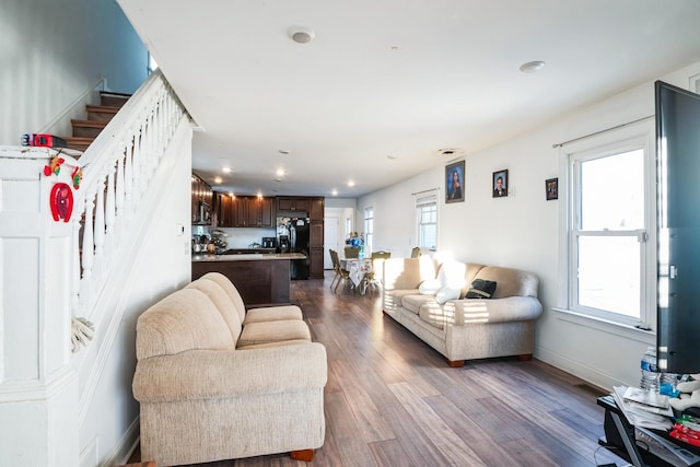 living area featuring baseboards, stairway, dark wood-style flooring, and recessed lighting