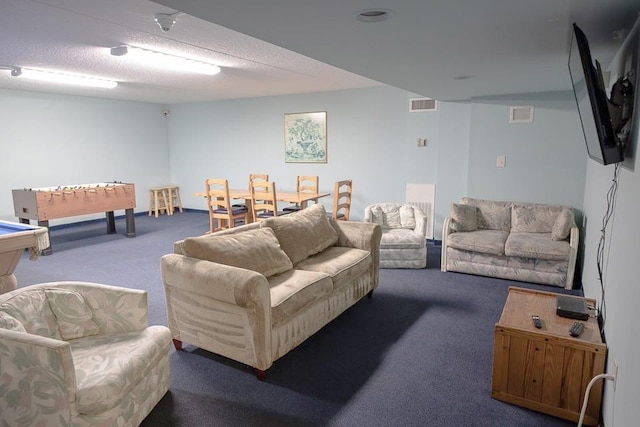 living room with a textured ceiling, carpet floors, and pool table