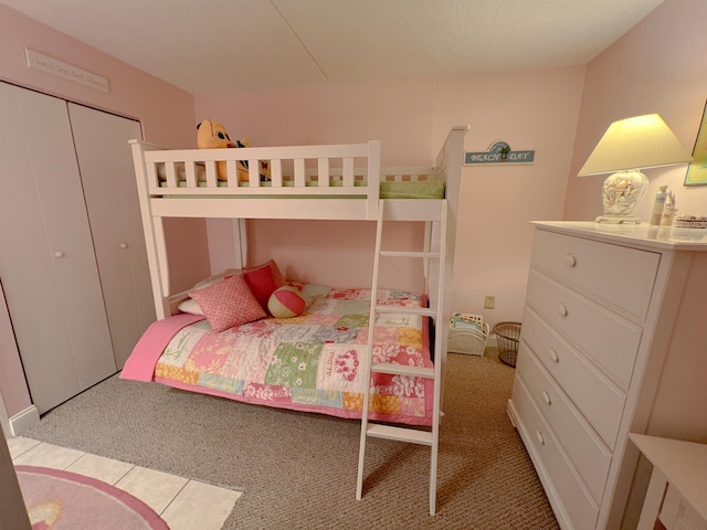 bedroom featuring light colored carpet and a closet