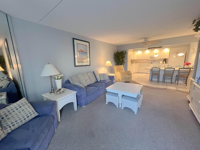 living room featuring ceiling fan and light carpet