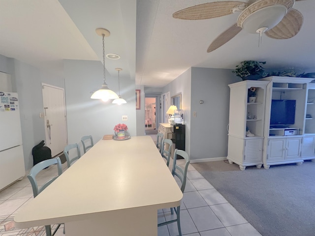 dining space with ceiling fan and light tile patterned floors