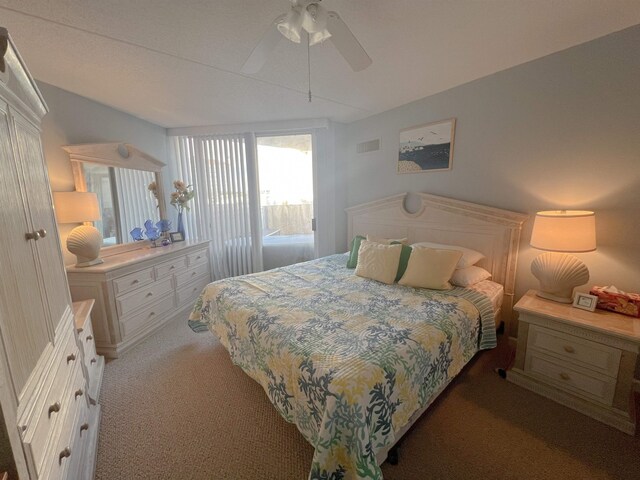 bedroom featuring ceiling fan and dark carpet