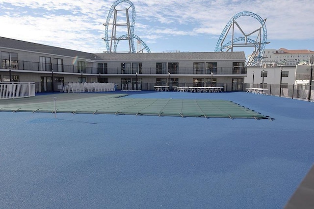 view of pool with basketball hoop