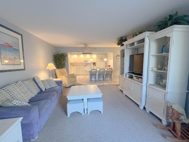 carpeted living room featuring ceiling fan and built in features