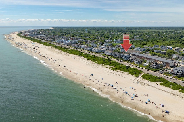 bird's eye view featuring a water view and a beach view