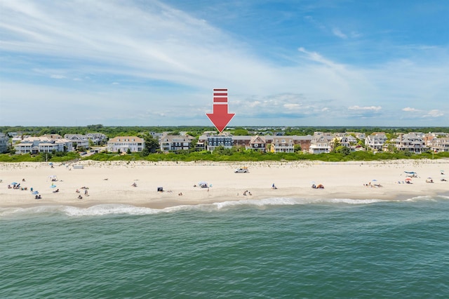 birds eye view of property with a view of the beach and a water view