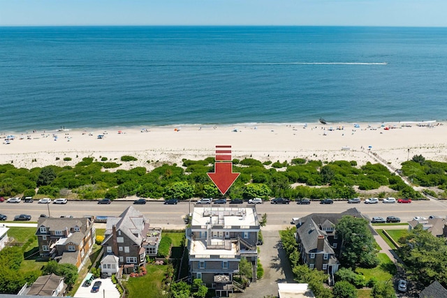 birds eye view of property featuring a water view and a view of the beach