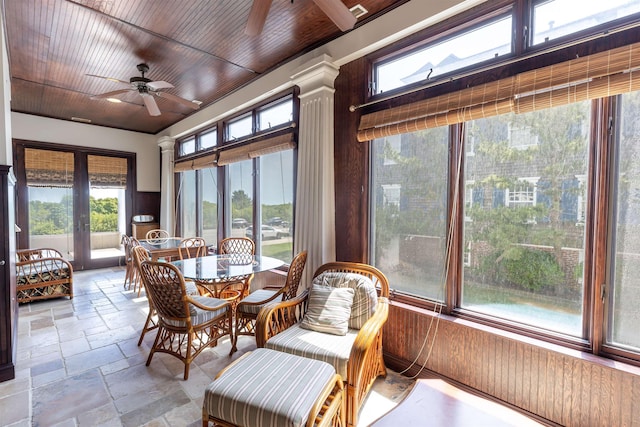 sunroom featuring french doors, ornate columns, ceiling fan, and wood ceiling