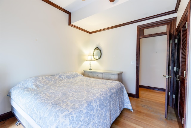 bedroom with light hardwood / wood-style floors and ornamental molding