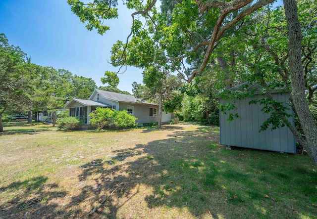 408 Princeton Ave, Cape May Point, NJ 08212 - view of green lawn featuring a storage unit