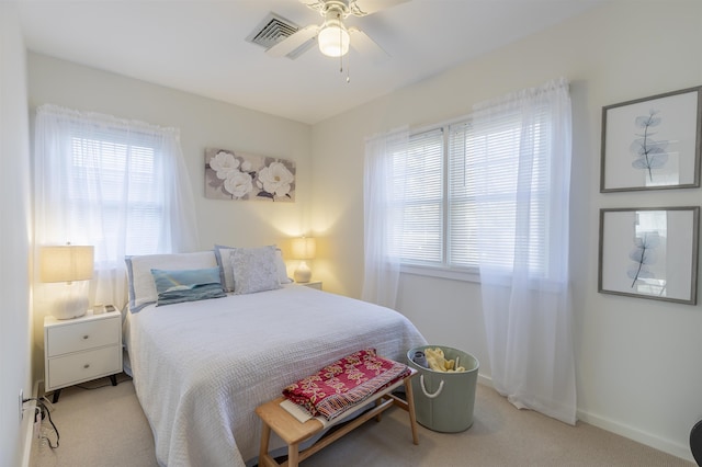 bedroom with light carpet, multiple windows, and visible vents