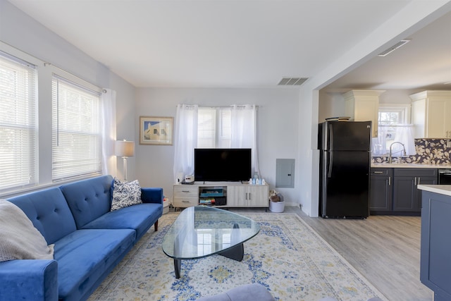 living room with light wood-type flooring and visible vents