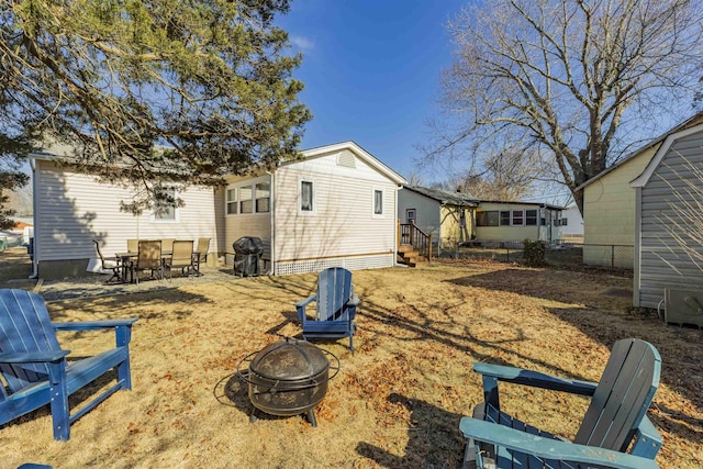 rear view of house featuring a fire pit and entry steps