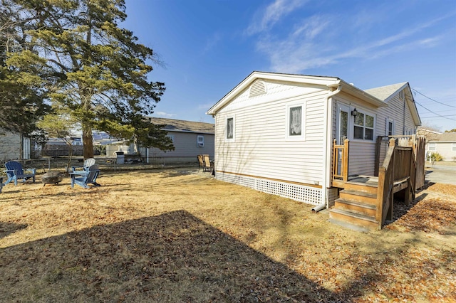 view of property exterior featuring a deck and fence