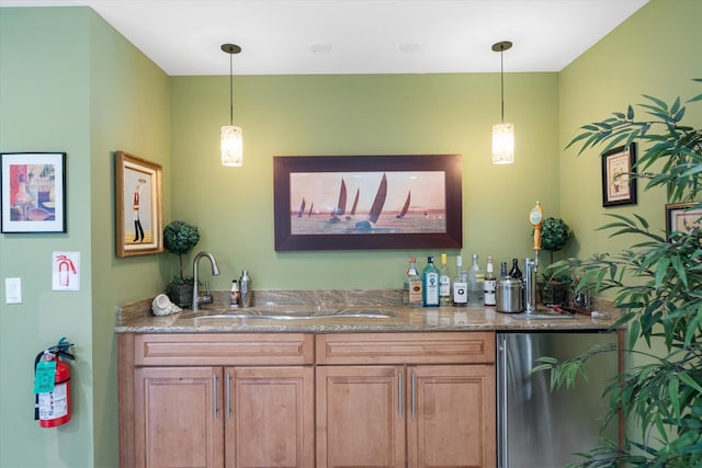 bar with stone countertops, decorative light fixtures, stainless steel refrigerator, and sink