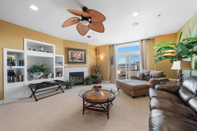 living room featuring ceiling fan, light colored carpet, and built in features