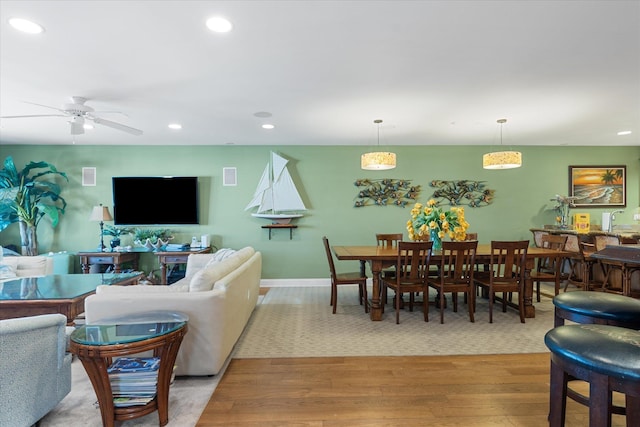 living room featuring ceiling fan and light wood-type flooring