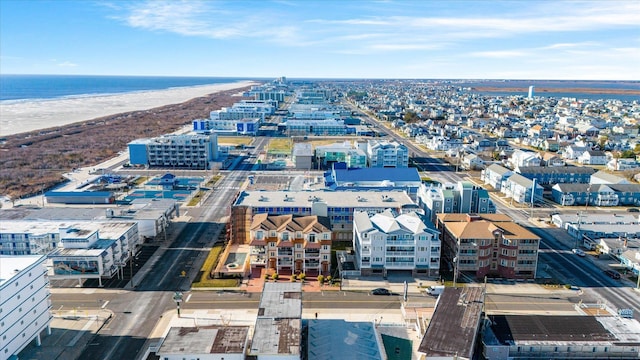 drone / aerial view featuring a water view and a beach view