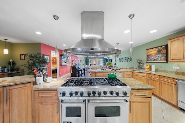 kitchen with light stone countertops, stainless steel appliances, island range hood, light tile patterned floors, and decorative light fixtures