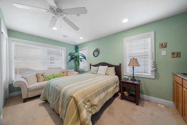 carpeted bedroom with ceiling fan and multiple windows