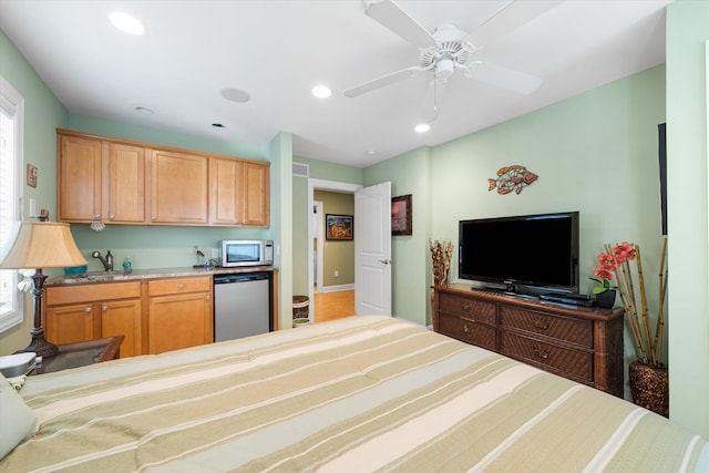 interior space with ceiling fan, sink, and stainless steel dishwasher