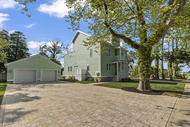 9 N 8th St, Del Haven, NJ 08251 - view of home's exterior featuring an outbuilding, a lawn, decorative driveway, and a detached garage