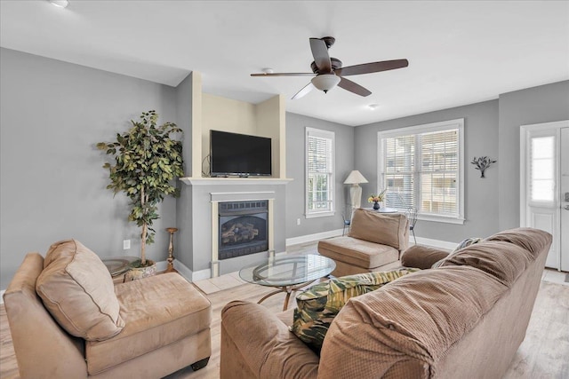 240 E Taylor Ave Unit 100, Wildwood, NJ 08260 - living room with light wood-type flooring, a ceiling fan, a fireplace with flush hearth, and healthy amount of natural light