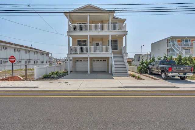 240 E Taylor Ave Unit 100, Wildwood, NJ 08260 - raised beach house with stairs, an attached garage, and driveway