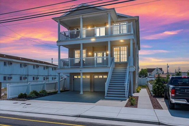 240 E Taylor Ave Unit 100, Wildwood, NJ 08260 - view of front facade with a balcony, stairs, a porch, driveway, and an attached garage