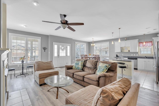 240 E Taylor Ave Unit 100, Wildwood, NJ 08260 - living room featuring a ceiling fan, a chandelier, and light wood finished floors