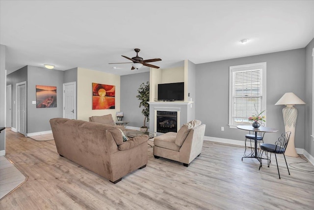 240 E Taylor Ave Unit 100, Wildwood, NJ 08260 - living room featuring a ceiling fan, a glass covered fireplace, and light wood-type flooring