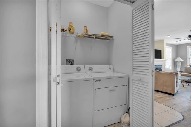 240 E Taylor Ave Unit 100, Wildwood, NJ 08260 - washroom featuring washing machine and clothes dryer, a fireplace, ceiling fan, and light wood-type flooring