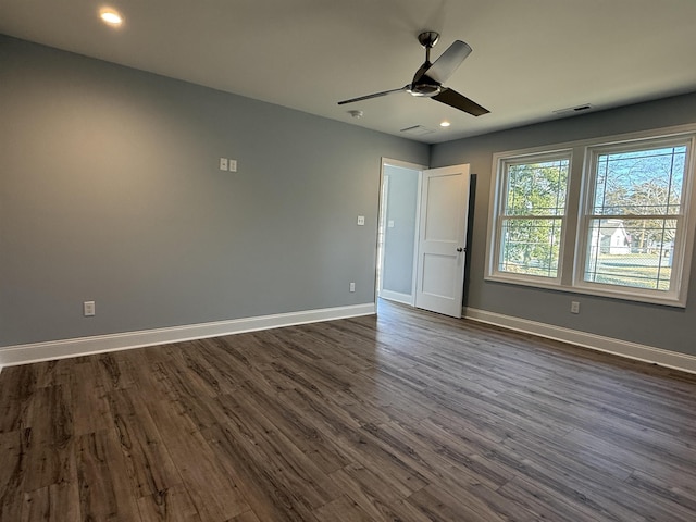 unfurnished bedroom with dark wood-style flooring, recessed lighting, visible vents, and baseboards